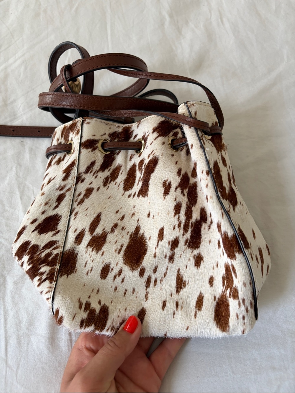The Mini Drawstring Crossbody Bucket Bag Cow Print - Picture 2 of 11